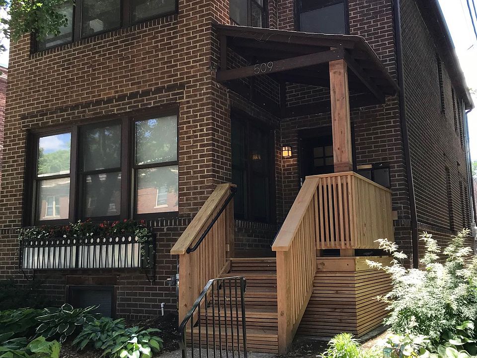 Solid brick 1917 Craftsman Duplex with new front porch and extensive landscaping.
