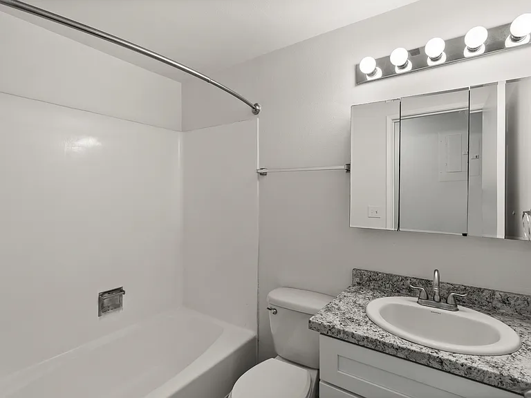 Bright Tacoma bathroom with a full tub and modern vanity. Bright Tacoma bathroom with a full tub and modern vanity.