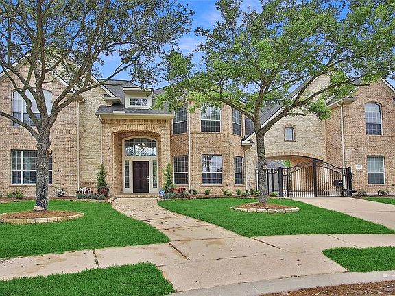 Featuring a private driveway gate with porte cochere, extended driveway and a 3 car garage. All brick home is in a quiet location within walking distance to parks and trails around the lakes.