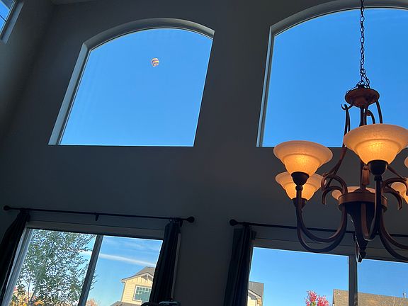 Views of hot air balloons overhead.