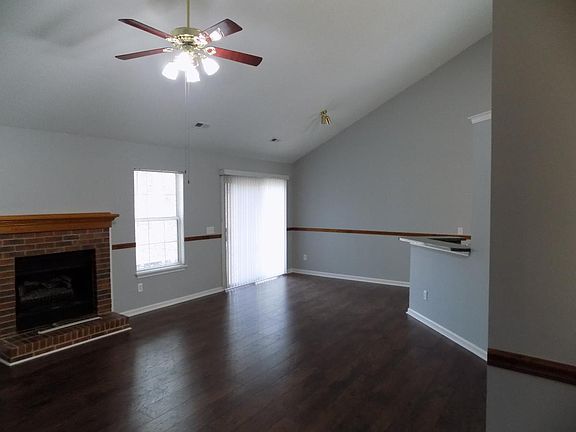 living room with fireplace and vaulted ceiling