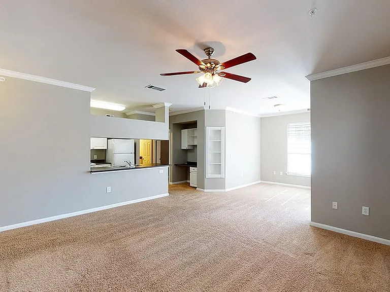 Gourmet kitchen, dining and living room with plush carpet.