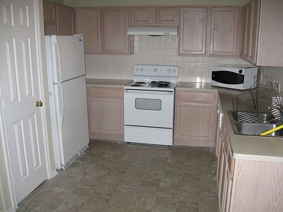 Kitchen with refridgerator and microwave that stays.  Large seperate panty.