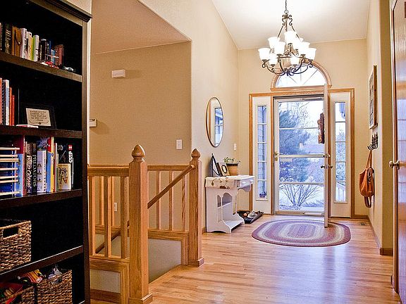 Front Entry with Stairway to Finished Basement and Hallway to upstairs Bedrooms on the Left. Front Door in the Center. Kitchen to the Right.