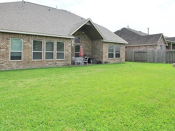Here's our first perspective of the Back of the Home, surrounded by a lush lawn.