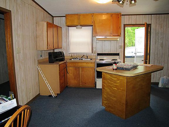 Kitchen area of cabin, open to living.