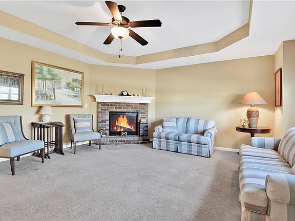 Step into the tiled entry way and immediately your view is an inviting living room with corner fire