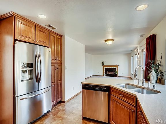 View from the kitchen looking into the family Room. The fireplace is equipped with a blower to add warmth on chilly nights.