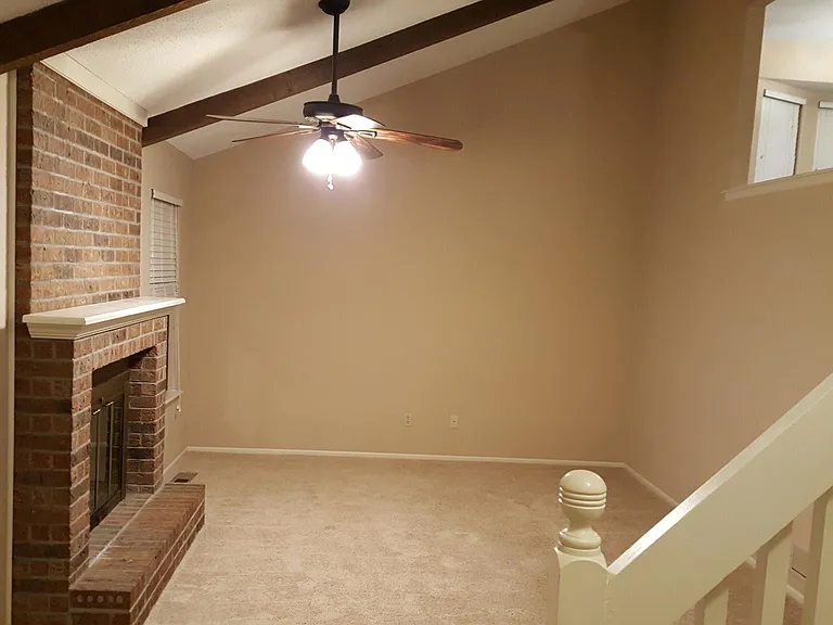 Living room has vaulted ceilings and is overlooked from the kitchen