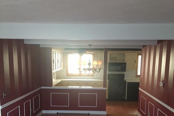 This room has been painted beige with white trim.