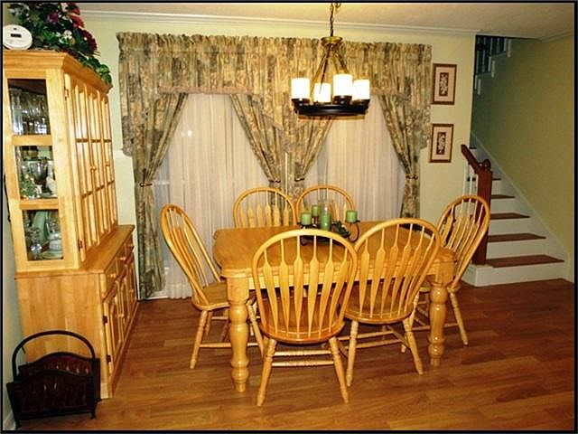 Formal dining room has laminate wood floors.