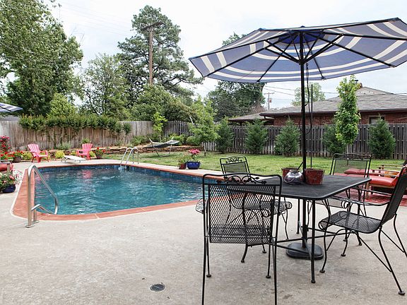 Large Pool Surrounded by New Landscape and a Privacy Fence
