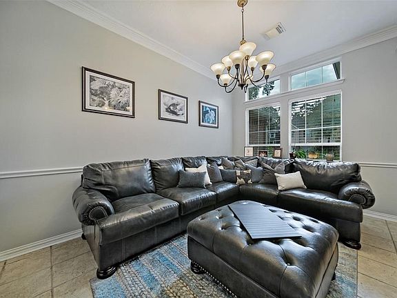 Formal dining with crown moulding is being used as a sitting room