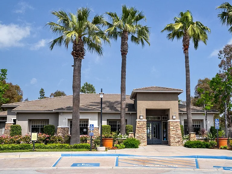 Leasing Office at Camino Real Apartments Framed by Palm Trees and Accessible Parking