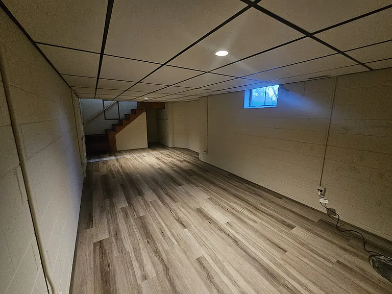 27x11 ft Basement with new paint and new LVP floors.