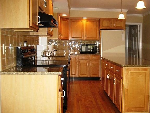Sparkling Kitchen with hardwood floors and granite countertop