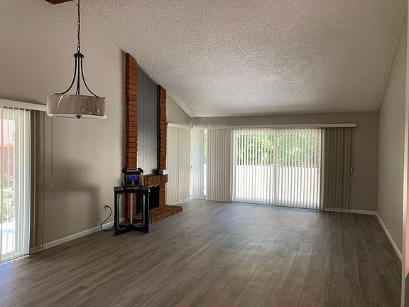 The living room with gas fireplace and plenty of windows for natural light and cross breeze!