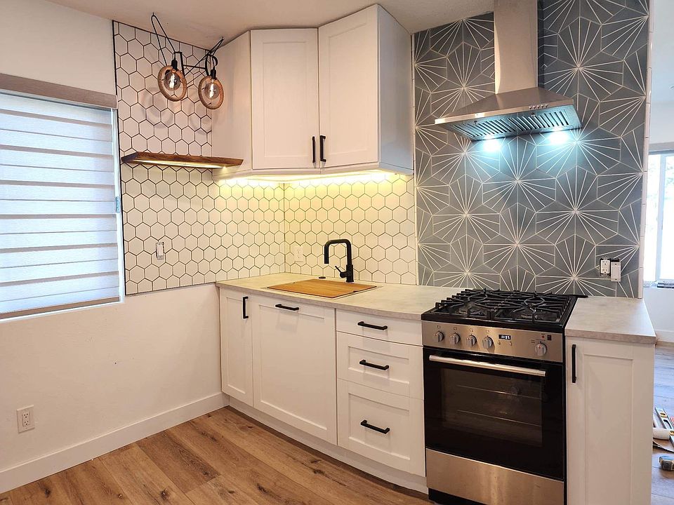 Beautiful custom tile and modern design kitchen. Thoughtful under cabinet and shelf lighting.
