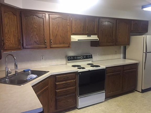 Kitchen with oven, fridge, and dishwasher