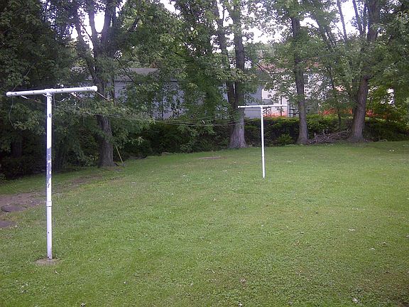 Back yard. Clothes lines. Tree lined creek.