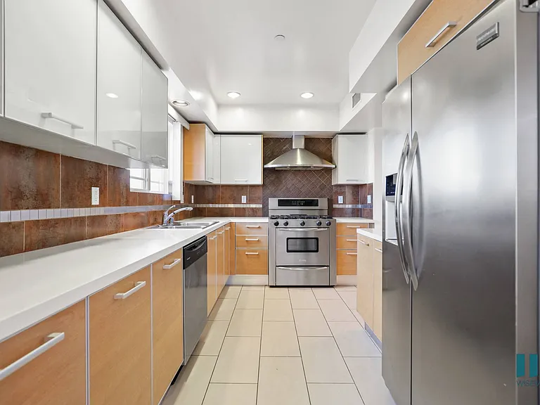 Large-Size Kitchen with Stainless-Steel Refrigerator, Stove, Microwave Oven, and Dishwasher