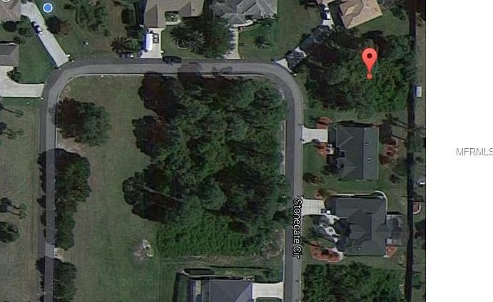 Overhead view of vacant lot - fence behind the lot provides privacy and surrounds the whole community.  Two lovely homes on either side of this home.  Plenty of room for a pool.