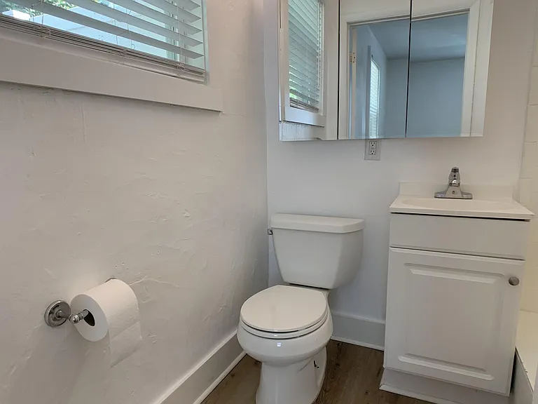 Bathroom has large tri-panel medicine cabinet for additional storage.