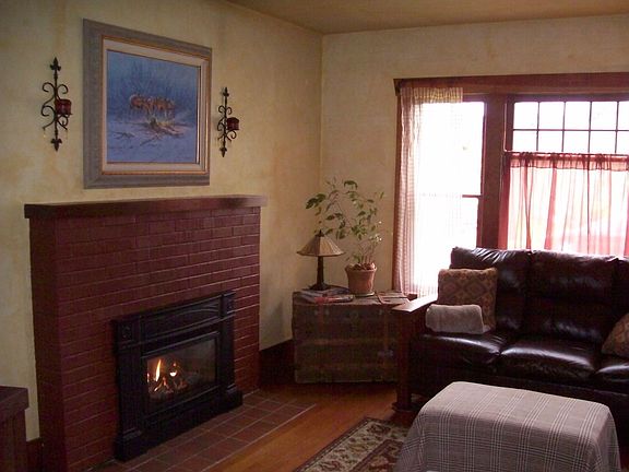 Living room with hardwood floors, gas fp, and large window for the natural sun