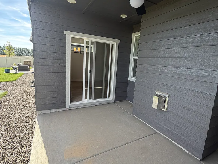 Step outside to the covered back porch, complete with a ceiling fan for added comfort and breathtaking views of the surrounding farmland. This peaceful outdoor retreat is the perfect place to enjoy.