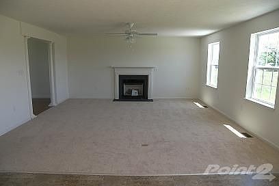 with gas fireplace and ceiling fan...
