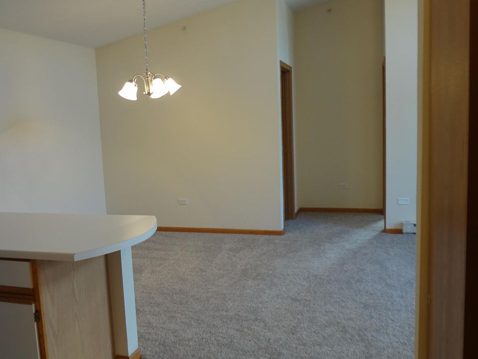 Unit features ceramic tile & newer carpet, appliances, window blinds & A/C unit