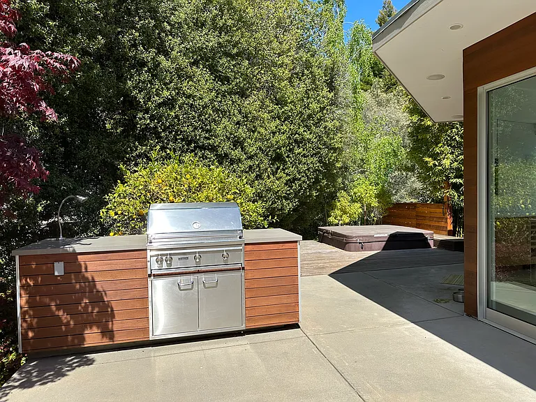 Step out from living/dining room area to patio with outdoor barbecue and soak in hot tub