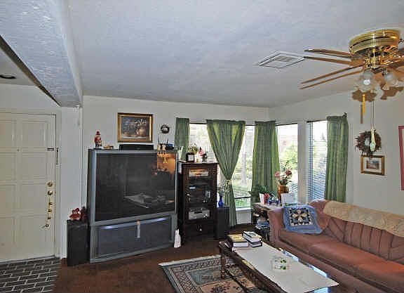  Living room off the entry is a nice size with cozy woodburning fireplace