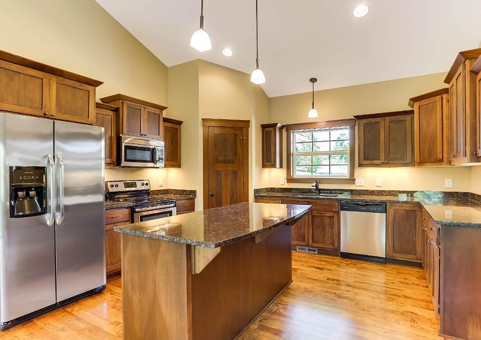 Open concept rambler is upgraded throughout w/ gourmet kitchen incl birch cabinets and flooring, granite counters, undercabinet lighting and SS appl. Many beautiful finishes in this home, all in pristine condition! One level living w/main flr laundry