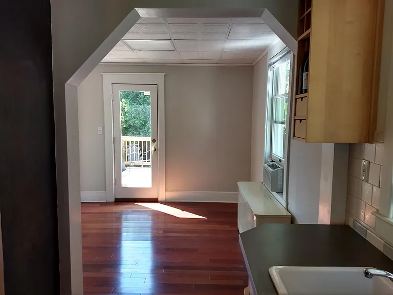Dining room that has door to deck.
Radiator and window air conditioner has been removed.