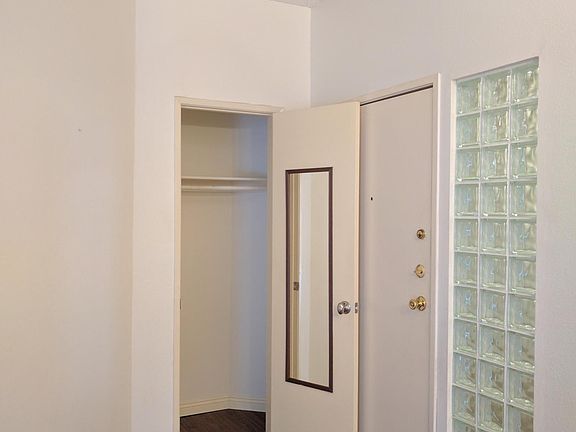 Doorway with coat closet.