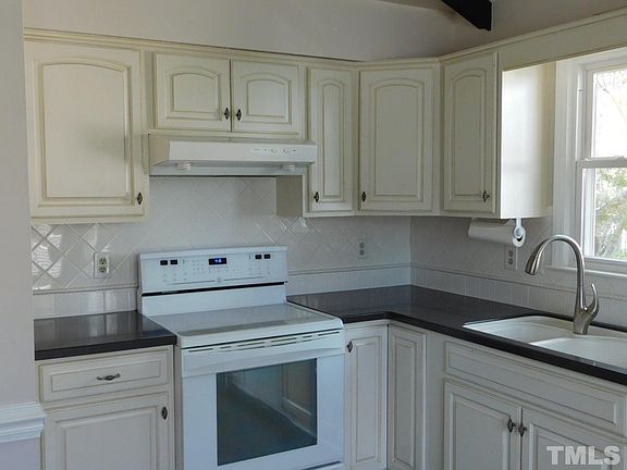 Modern kitchen includes oven, dishwasher, and refrigerat0r.