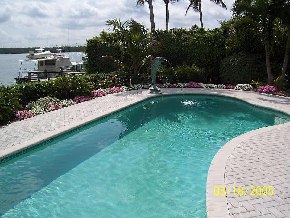 Pool and spa with open view of water.