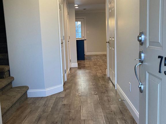 Foyer with coat closet, 1/2 bath, entry to garage & stairs to 2nd floor.