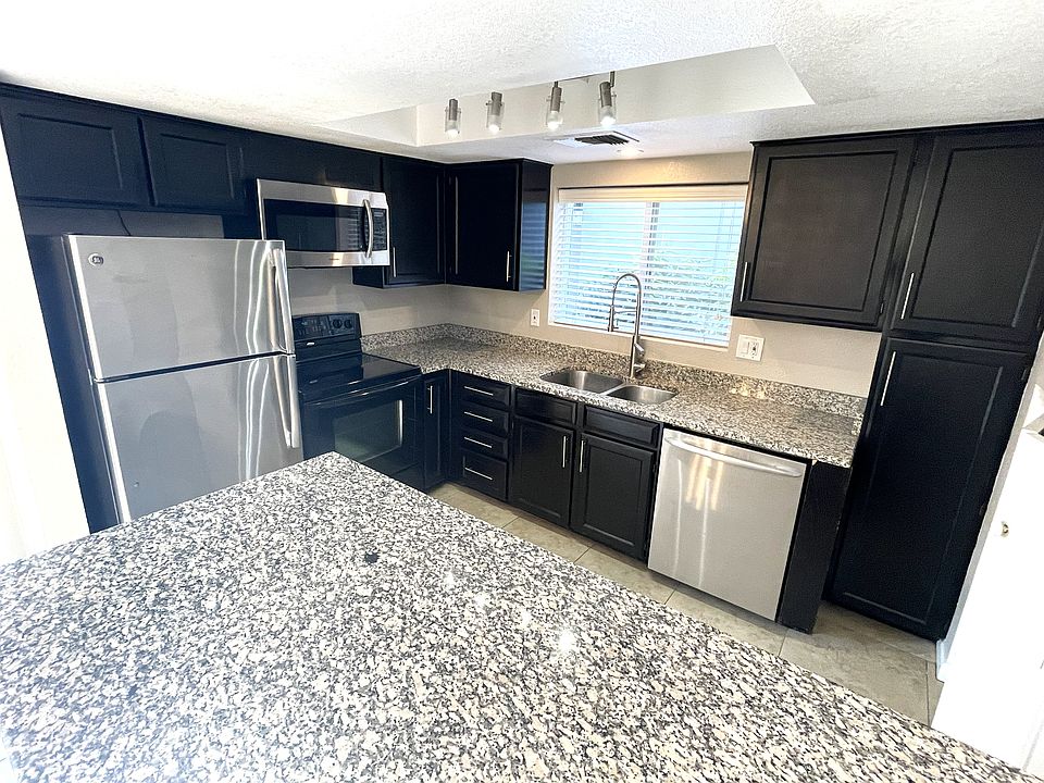 Kitchen with counter opening to living / dining room