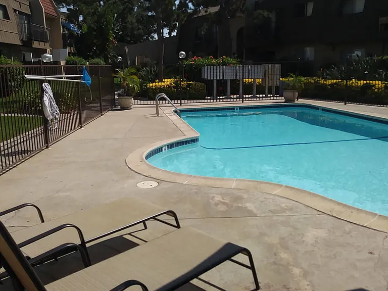Swimming pool with beautiful surroundings at Teton Pines Apartments in Escondido, California.
