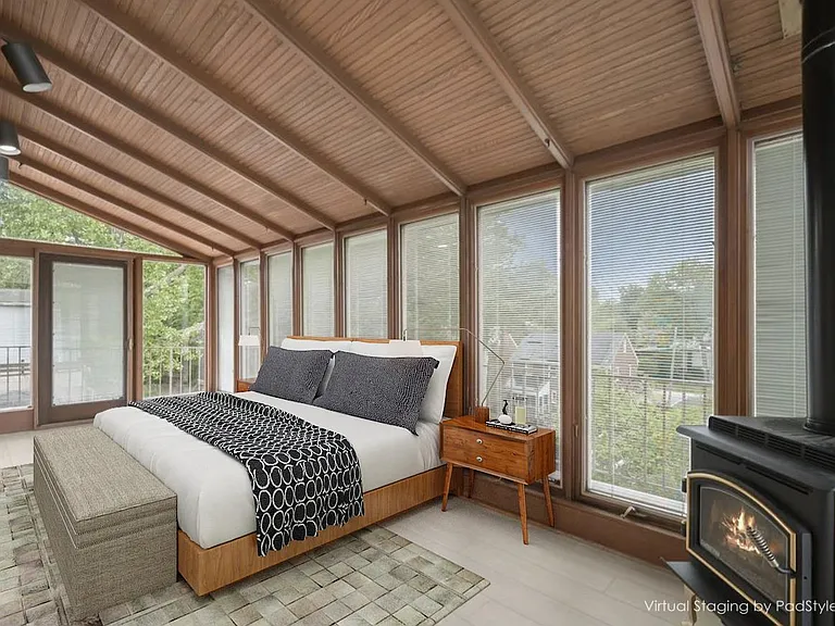 West-side bedroom with door to outside walkway, overlooking rear yard and working gas log fireplace and Pella windows