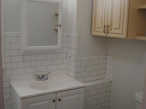 Brand New Bathroom. New sink, vanity, tile, commode, and ca