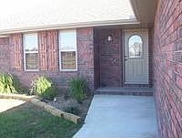 Charming wooden shutter accents and landscaping
