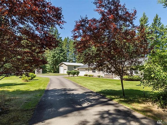 Entering from the powered electric gate, plenty of parking as the property offers a circular driveway, 2 car garage, plus the shop!