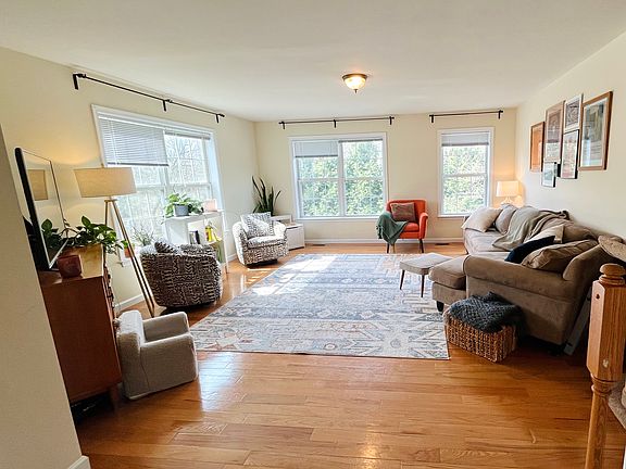 Level 2: Spacious light-filled living room. Powder room to photo left.