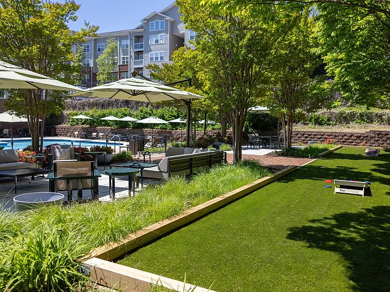 Outdoor lounge with cornhole