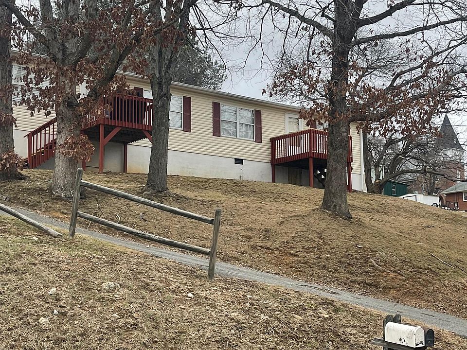 Front (Note driveway circles around parking is in rear and enter at ground level)