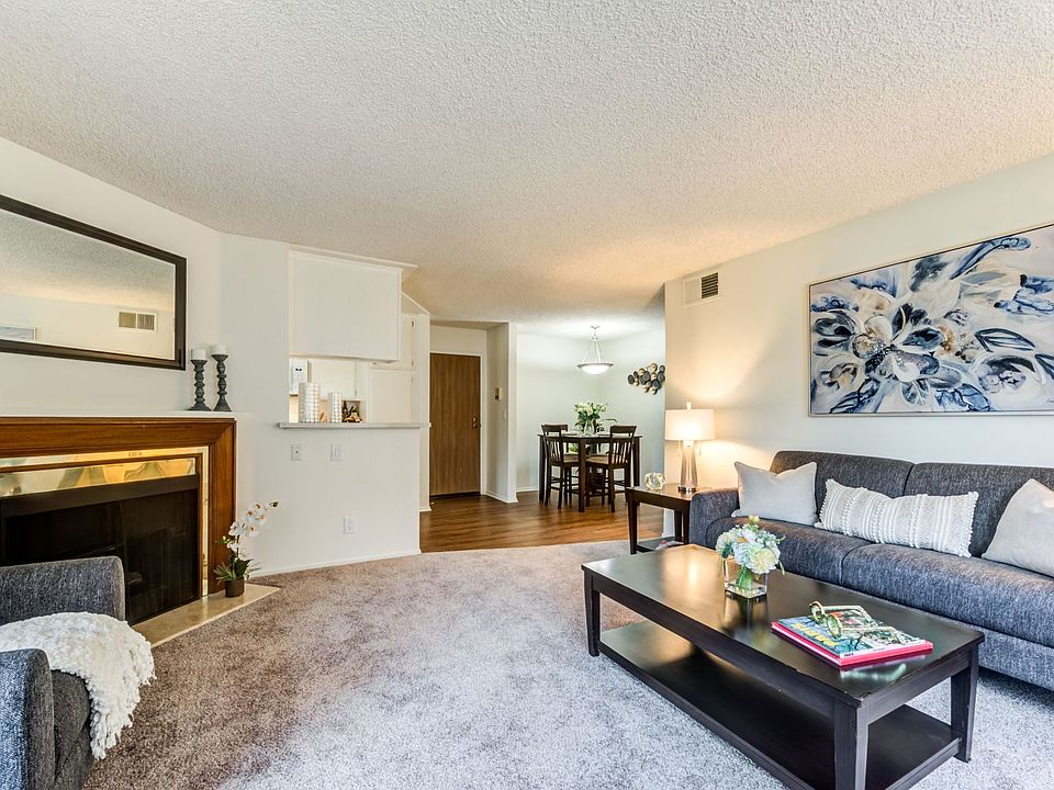 Spacious living room with a fireplace at the Plaza Apartments in Sherman Village