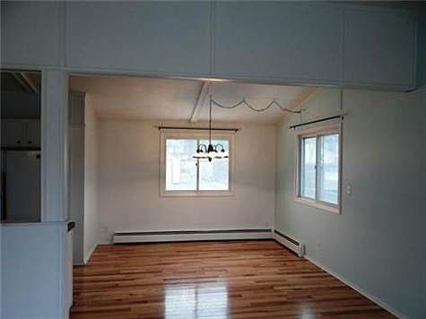 The Formal Dining Room With Vaulted Ceilings & Hickory Wood Floo